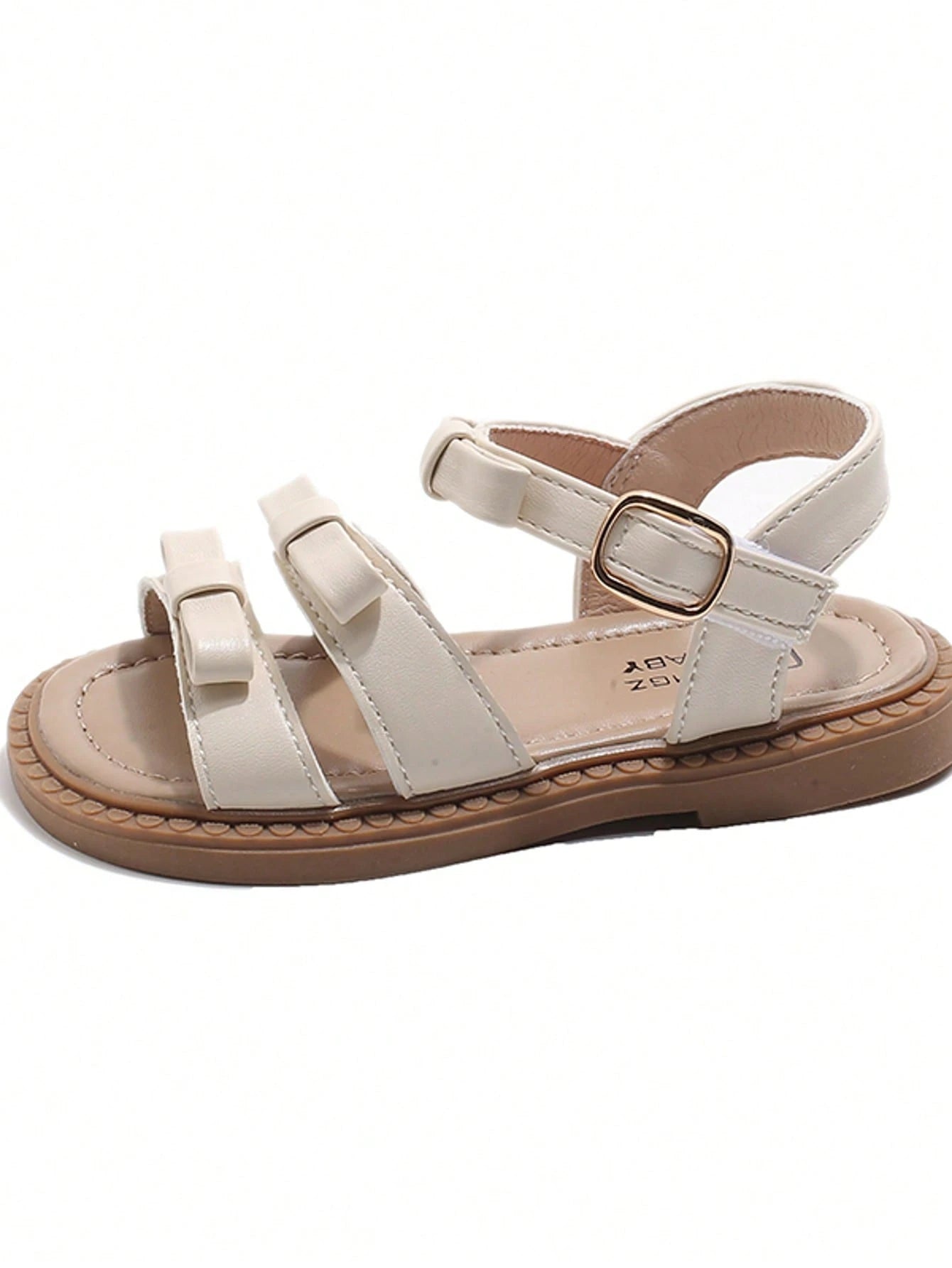 This Beige Children's Sandal Features Multiple Straps And A Bow Decoration, With A Metal Buckle Design For A Refined Touch. The Sole Is In A Brown Color. The Sweet And Cute Style Belongs To The Summer